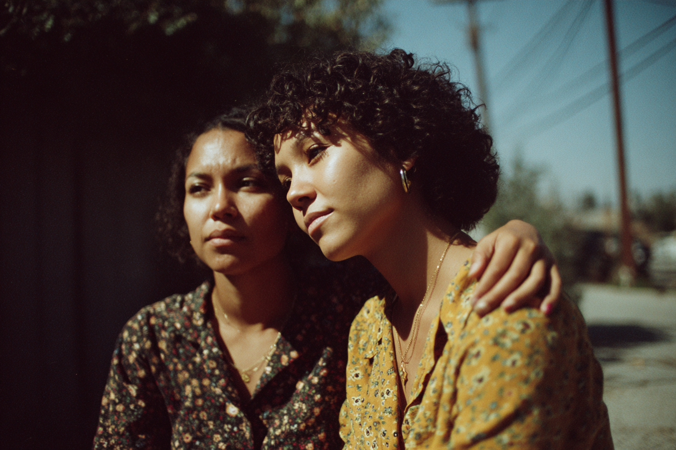 Two women in warm golden light, hope and new beginnings